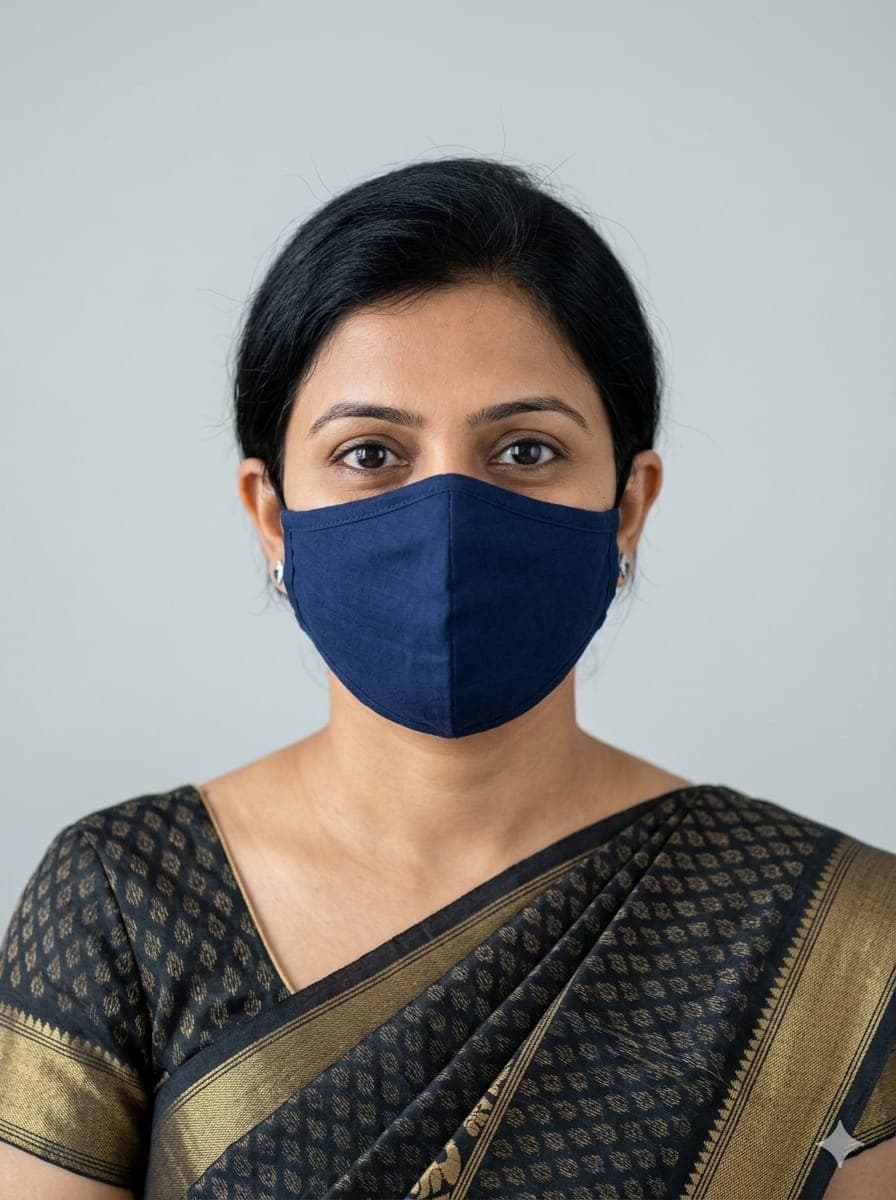 Portrait of a Massazo-verified dadi in a saree, wearing a clean mask